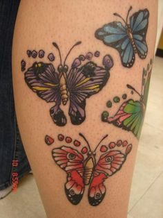 a woman's leg with tattoos on it that has three butterflies and one butterfly