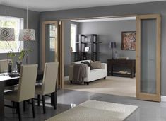 a dining room table and chairs in front of a sliding glass door that leads to the living room