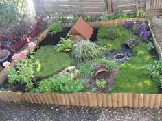 an outdoor garden with grass, rocks and flowers in the center is shown from above