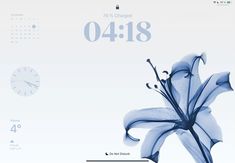 a blue flower is in front of a white background with the date and time on it