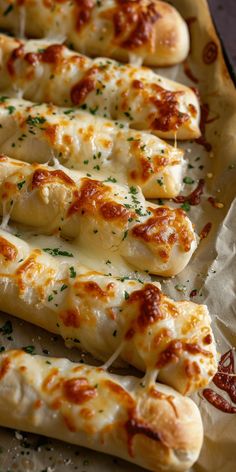 some bread sticks with cheese and sauce on them