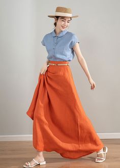 "This orange A-line linen midi skirt is made from high-quality linen material, which is soft, comfortable, and breathable. The bright and vibrant color makes you stand out in the crowd. The wide hemline adds an elegant and flowing movement to your look. The high-waisted design highlights your waistline, creating a flattering silhouette. Pair it with a lace top or a loose-fitting t-shirt to create different fashion styles. This skirt is suitable for various occasions such as dates, parties, and v Orange Mini Skirt Bottoms With Pockets, Orange Relaxed Flared Skirt, Orange Mini Skirt With Pockets, Orange Relaxed Full Skirt, Orange Skirt With Pockets For Spring, Spring Orange Skirt With Pockets, Orange Summer Skirt With Pockets, Orange Skirt Bottoms With Pockets, Long Wrap Skirt With Pockets