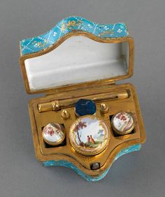 an antique porcelain trinket box with three plates in it