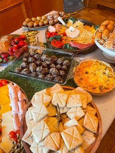 a table filled with lots of different types of food and desserts on top of it