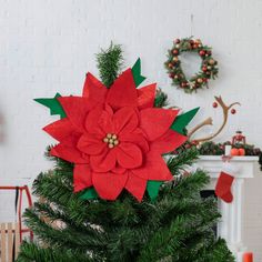 a christmas tree decorated with red poinsettia