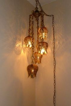 a chandelier hanging from the ceiling in a room with white walls and flooring