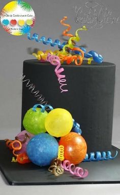 a birthday cake with balloons and streamers on top