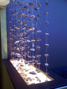 a display case with many different types of items on it's sides and hanging from the ceiling