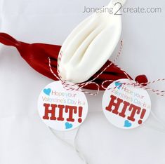 two valentine's day gift tags on a red ribbon