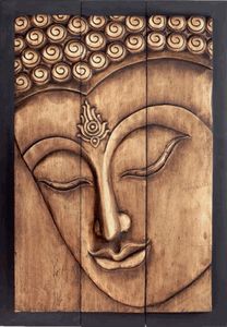 a wooden wall hanging with a buddha face on it