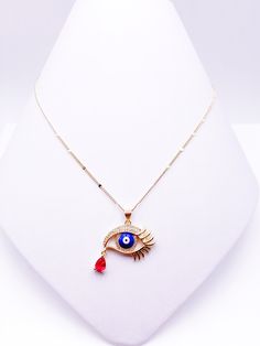 "Protection Evil Eye Pendant Beautiful and modern 18-carat gold-plated necklace for women, with a Beautiful Gold-plated Evil Eye Crystal pendant. A minimalist, everyday necklace that goes with anything, This necklace is designed to be worn all day. DETAILS: Necklace length: Max: 18\" Inches It is carefully shipped in a beautiful organza pouch, bubble wrapped and well protected. 100% Satisfaction Guarantee. **Leslie Boules is a brand that is born from the desire to create new jewelry accessories Gold Plated Teardrop Pendant Chain Necklace As Gift, Gold Chain Necklace With Evil Eye As Gift, Gold Chain Necklace With Evil Eye For Gift, Fine Jewelry Red Gold Plated Necklace, Fine Jewelry Red Gold-plated Necklace, Yellow Gold Plated Necklace As Gift, Yellow Gold Plated Necklace For Gift, Red Gold-plated Fine Jewelry Necklace, Elegant Gold Evil Eye Necklaces