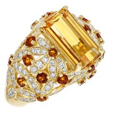 This One of a Kind Juleve Precious Topaz, Citrine, & Diamond Floral Design Ring. The Ring is Crafted in 14 Karat Yellow Gold & Features a 4.09 Carat Center Emerald Cut Precious Topaz. The Center Precious Topaz is accompanied by a Floral Design of Round Citrines that Weigh 0.65 Carats total Weight & 0.79 Carats of round Diamonds. Yellow Topaz Jewelry, Chicken Receipes, Sweet Jewelry, Round Diamond Setting, Citrine Jewelry, Imperial Topaz, Topaz Jewelry, Fantasy Closet, Floral Ring