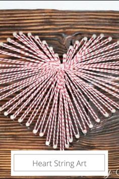 heart string art is displayed on a wooden surface with text overlay that reads, heart string art