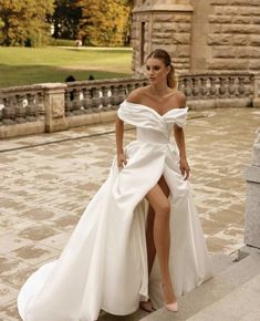 a woman in a white dress is posing for the camera with her legs spread out