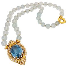 This majestic necklace features a showstopping 43.50 carat Oval Blue Topaz set in an elaborate 18 karat yellow gold and Diamond setting. The pendant is set on a strand of natural colored Aquamarine beads. The faceted beads are spaced with 18 karat yellow gold rondelles . The length of the beads is 19" and the pendant measures 2" Total Diamond Weight 5.04 carats Stamped 750 Appraisal upon request Blue Topaz Necklace, Necklace Beads, Aquamarine Beads, Topaz Necklace, Chic Earrings, Dream Jewelry, Blue Topaz, Aquamarine, Gold Diamond