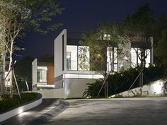 a modern house is lit up at night