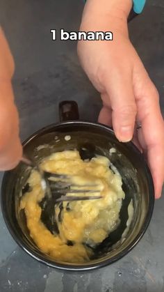 a person mixing food in a bowl with a fork