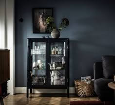 a black cabinet with glass doors in a living room