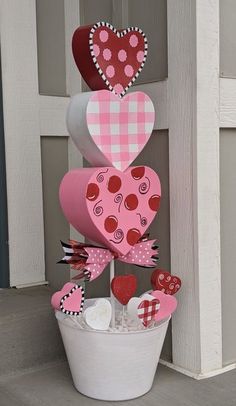 a bucket filled with hearts sitting next to a door