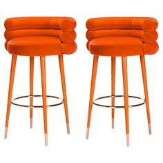 two orange stools sitting next to each other