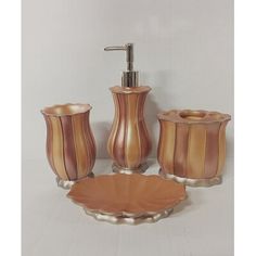 a bathroom set consisting of soap dispenser, toothbrush holder and cup