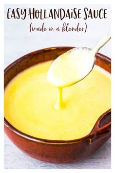 a spoon full of homemade hollandaise sauce in a brown bowl with the words easy hollandaise sauce made in a blender