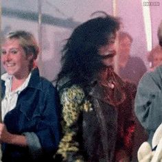 two women are standing next to each other and one is holding a white teddy bear