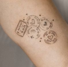 a woman's arm with stamps on it and the word love written in black ink