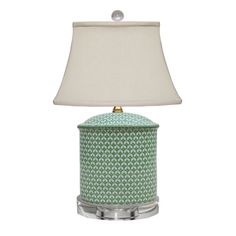 a green and white lamp with a shade on the top, sitting in front of a white background