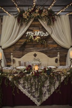 the table is set with candles and flowers for an elegant wedding reception at mr & mrs amana