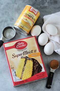 ingredients to make a cake including eggs, butter and chocolate on a table with flour