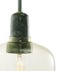 a green light hanging from a ceiling fixture