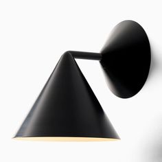 a black wall light with a white background