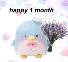 a blue bird with a pink bow and purple flowers on it's head is next to a card that says happy 1 month