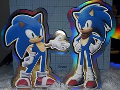 two sonic the hedgehog magnets are next to each other in front of a wall