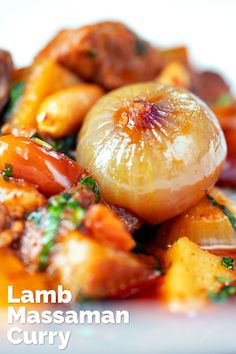 a close up of food on a plate with the words lamb massanan curry