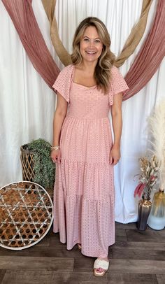 Description Dress to impress with this dusty pink eyelet maxi dress. Perfect for spring events, family photos, and Mother's Day, this dress features short flutter sleeves and a flowy, tiered style. The unique square neckline adds a touch of elegance to this feminine and stylish dress. Dusty pink eyelet maxi dress Short flutter sleeves Square neckline Tiered and flowy style Stretchy Lined 97% polyester, 3% spandex Size Guide This dress fits true to size. Carley is wearing the size small. Jenn is Sunday Dresses, Spring Events, Maxi Dress Short, Eyelet Maxi Dress, Long Summer Dresses Maxi, Flowy Style, Dress Dusty, Bottom Clothes, Flutter Sleeves