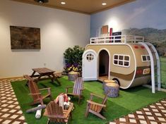 a room with lawn chairs and a camper on the grass in front of it