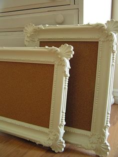 two white frames sitting on top of a hard wood floor