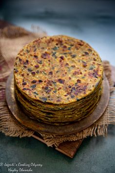 a stack of food sitting on top of a wooden plate