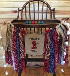 an old rocking chair decorated with red, white and blue ribbons