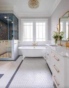 a large bathroom with white and gold fixtures