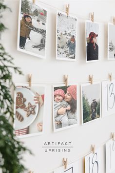 a wall with pictures hanging on clothes pins