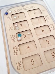 a close up of a wooden calculator with numbers and beads on the front