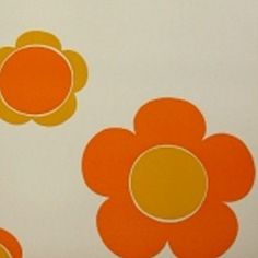 an orange and yellow flower pattern on a white wallpaper with circles in the center