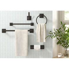 an image of a bathroom setting with towel racks and towels hanging on the wall above it