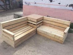 three wooden benches sitting next to each other on the ground in front of a building