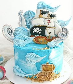 a blue cake with a pirate ship on top