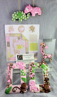 some pink giraffes and monkey decorations are on display