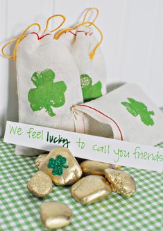 two bags filled with candy sitting on top of a green and white checkered table cloth